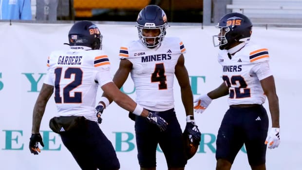 Wide receiver Kelly Akharaiyi celebrates with his former teammates. 