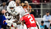 Texas Longhorns running back Quintrevion Wisner (26) runs through Ohio State defense in the second quarter as the Texas Longhorns play the Ohio State Buckeyes in the Cotton Bowl College Football Playoff semi-final at AT&T Stadium in Dallas, Texas, Jan. 10, 2025.