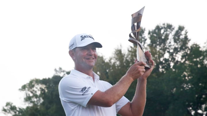 PGA Tour player Lucas Glover poses for a portrait with the FedEx St. Jude Championship trophy.