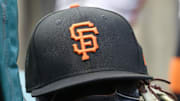 Jul 14, 2023; Pittsburgh, Pennsylvania, USA;  San Francisco Giants hat and glove on the bench against the Pittsburgh Pirates during the first inning at PNC Park. 