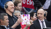 Pac-12 basketball analyst Bill Walton and announcer Dave Pasch hold up drawings for the camera during a game between the Arizona Wildcats and Washington Huskies in 2019.