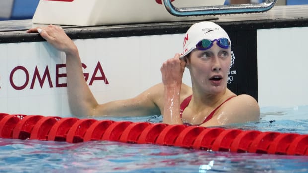 Taylor Ruck (CAN) reacts after swimming in the women's 100m backstroke 