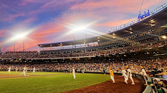 A cotton candy sky is seen from the third base photographers well during game one of the NCAA College World Series finals at Charles Schwab Field in Omaha, Neb., on Saturday, June 22, 2024.