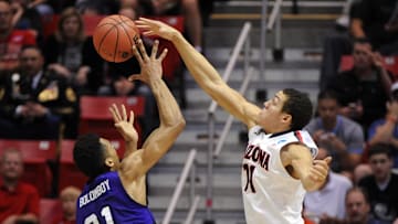 Mar 21, 2014; San Diego, CA, USA; Arizona Wildcats forward Aaron Gordon (11) blocks the shot of Weber State Wildcats forward Joel Bolomboy (21) in the first half of a men's college basketball game during the second round of the 2014 NCAA Tournament at Viejas Arena. Mandatory Credit: Christopher Hanewinckel-Imagn Images