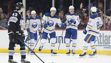 Buffalo Sabres defenseman Mattias Samuelsson (23) celebrates his goal in front of New Jersey Devils defenseman Luke Hughes (43): Vincent Carchietta-Imagn Images