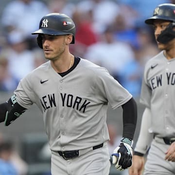 Oct 5, 2025; Toronto, Ontario, CAN; New York Yankees Cody Bellinger (35) is congratulated after hitting a two-run home run in the sixth inning against the Toronto Blue Jays during game two of the ALDS round for the 2025 MLB playoffs at Rogers Centre. Mandatory Credit: John E. Sokolowski-Imagn Images