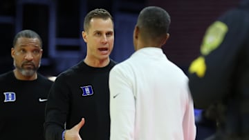 Feb 17, 2025; Charlottesville, Virginia, USA; Duke basketball head coach Jon Scheyer (L) sakes hands with Virginia Cavaliers head coach Ron Sanchez (R) after their game at John Paul Jones Arena. 