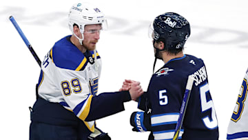 May 4, 2025; Winnipeg, Manitoba, CAN; St. Louis Blues left wing Pavel Buchnevich (89) and Winnipeg Jets defenseman Luke Schenn (5) shake hands after the Winnipeg Jets won in double overtime in game seven of the first round of the 2025 Stanley Cup Playoffs at Canada Life Centre. Mandatory Credit: James Carey Lauder-Imagn Images