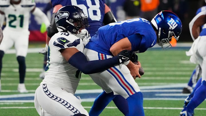 Oct 2, 2023; East Rutherford, New Jersey, USA; New York Giants quarterback Daniel Jones (8) is sacked by Seattle Seahawks linebacker Uchenna Nwosu (10) in the second half at MetLife Stadium. Mandatory Credit: Robert Deutsch-Imagn Images