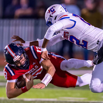 A John Curtis defender makes the tackle on Teurlings Catholic QB Alex Munoz