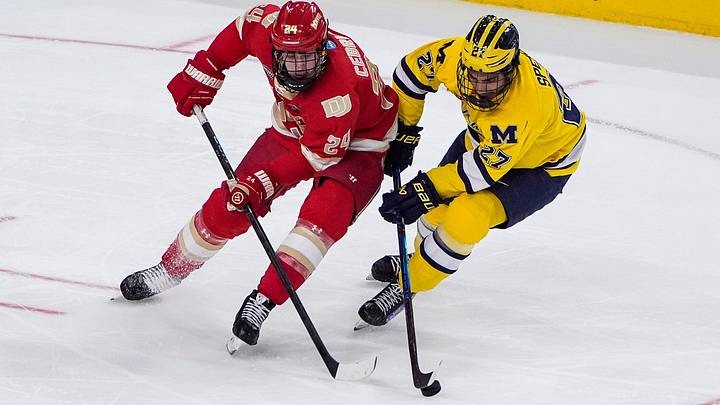 Michigan forward Malcolm Spence (27) defends Denver forward Kieran Cebrian (24) during the second period of the Frozen Four semifinal at T-Mobile Arena in Las Vegas on Thursday, April 9, 2026 Michigan forward Malcolm Spence (27) defends Denver forward Kieran Cebrian (24) during the second period of the Frozen Four semifinal at T-Mobile Arena in Las Vegas on Thursday, April 9, 2026