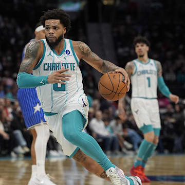 Oct 30, 2025; Charlotte, North Carolina, USA; Charlotte Hornets forward Miles Bridges drives to the basket against Orlando Magic forward Paolo Banchero (5) during the second half at Spectrum Center. Mandatory Credit: Jim Dedmon-Imagn Images