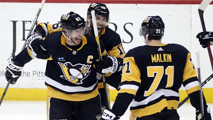 Mar 7, 2023; Pittsburgh, Pennsylvania, USA;  Pittsburgh Penguins center Sidney Crosby (87) reacts with left wing Jason Zucker (16) and center Evgeni Malkin (71) after Crosby scored the game winning power play goal in overtime against the Columbus Blue Jackets at PPG Paints Arena. Pittsburgh won 5-4 in overtime. Mandatory Credit: Charles LeClaire-Imagn Images