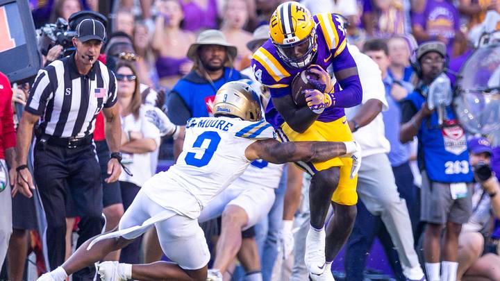 Sep 21, 2024; Baton Rouge, Louisiana, USA;  LSU Tigers tight end Trey'Dez Green (14) runs after a catch against UCLA Bruins defensive back Devin Kirkwood (3) during the second half at Tiger Stadium. Mandatory Credit: Stephen Lew-Imagn Images