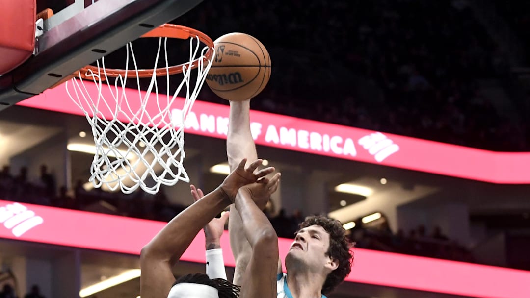 Dec 29, 2025; Charlotte, North Carolina, USA;  Charlotte Hornets center PJ Hall (16) rebounds against Milwaukee Bucks center Myles Turner (3) during the second half at the Spectrum Center. Mandatory Credit: Sam Sharpe-Imagn Images