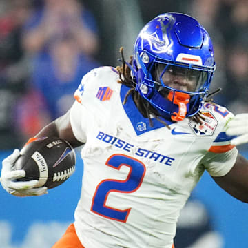 Boise State Broncos running back Ashton Jeanty (2) runs past Penn State Nittany Lions linebacker Kobe King (41) during their Vrbo Fiesta Bowl matchup at State Farm Stadium on Dec. 31, 2024.