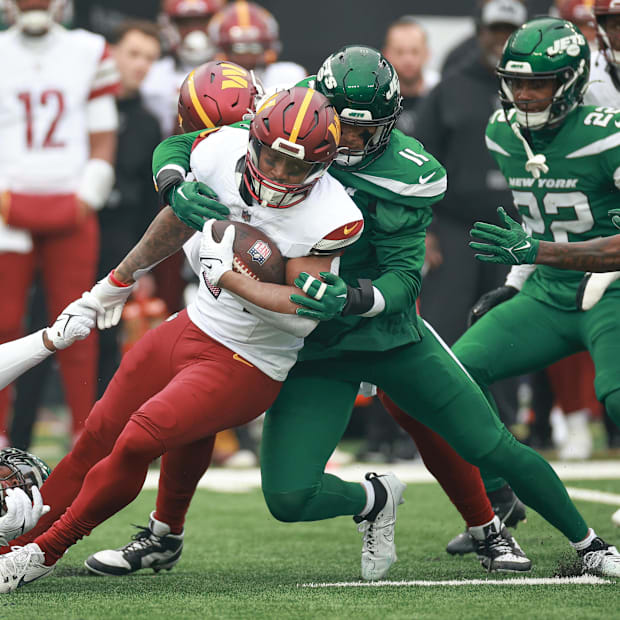 Washington Commanders running back Antonio Gibson is tackled by New York Jets linebacker Jermaine Johnson