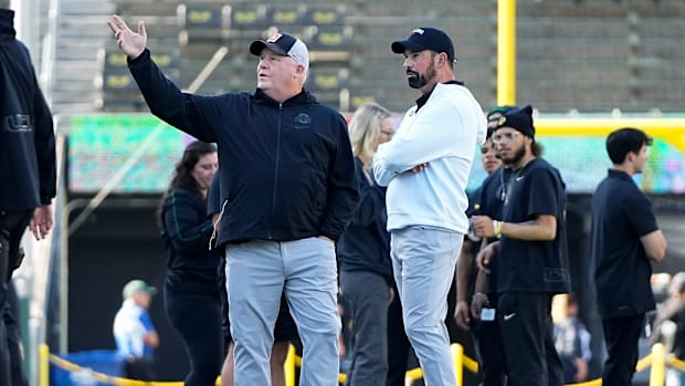 Oct 12, 2024; Eugene, Oregon, USA; Ohio State Buckeyes head coach Ryan Day talks to offensive coordinator Chip Kelly prior to
