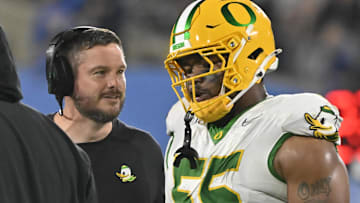 Sep 28, 2024; Pasadena, California, USA; Oregon Ducks head coach Dan Lanning talks to Oregon Ducks defensive lineman Derrick Harmon (55) during the fourth quarter at Rose Bowl. Mandatory Credit: Robert Hanashiro-Imagn Images