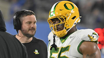 Sep 28, 2024; Pasadena, California, USA; Oregon Ducks head coach Dan Lanning talks to Oregon Ducks defensive lineman Derrick Harmon (55) during the fourth quarter at Rose Bowl. Mandatory Credit: Robert Hanashiro-Imagn Images