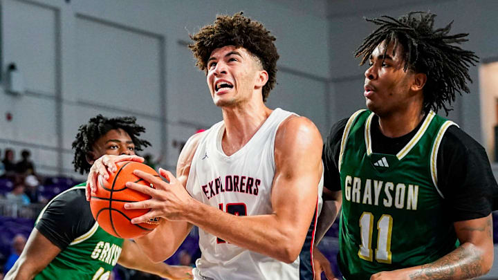 Columbus Explorers forward Cameron Boozer (12) drives to the basket as Grayson Rams forward Amir Taylor (11) guards him during the third quarter of a City of Palms Classic quarterfinal game at Suncoast Credit Union Arena in Fort Myers, Fla., on Friday, Dec. 20, 2024.