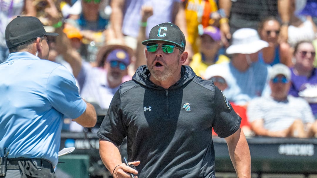 Jun 22, 2025; Omaha, Neb, USA;  Coastal Carolina Chanticleers head coach Kevin Schnall (9) gets thrown out of the game arguing with the umpires during the game against the LSU Tigers during the first inning at Charles Schwab Field. Mandatory Credit: Steven Branscombe-Imagn Images