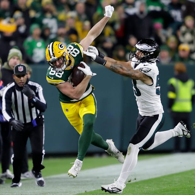 Green Bay Packers tight end Luke Musgrave (88) is shoved out of bounds by Philadelphia Eagles linebacker Zack Baun.