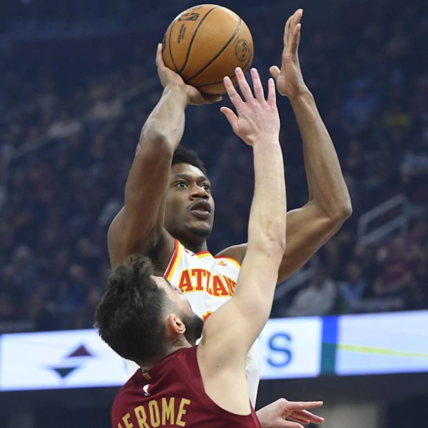 De'Andre Hunter (12) shoots beside Cleveland Cavaliers guard Ty Jerome (2)