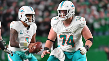 Miami Dolphins quarterback Tua Tagovailoa and OL Liam Eichenberg (74)