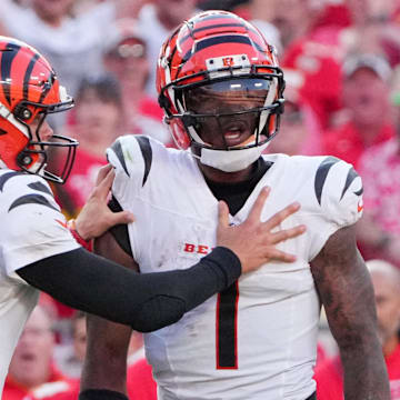 Sep 15, 2024; Kansas City, Missouri, USA; Cincinnati Bengals quarterback Joe Burrow (9) restrains wide receiver Ja'Marr Chase (1) after an altercation with officials during the second half of the game against the Kansas City Chiefs at GEHA Field at Arrowhead Stadium. Mandatory Credit: Denny Medley-Imagn Images