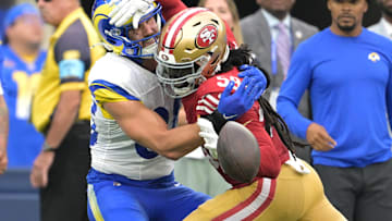 San Francisco 49ers linebacker De'Vondre Campbell (59) fouls Los Angeles Rams tight end Tyler Higbee (89) in the fourth quarter at SoFi Stadium.
