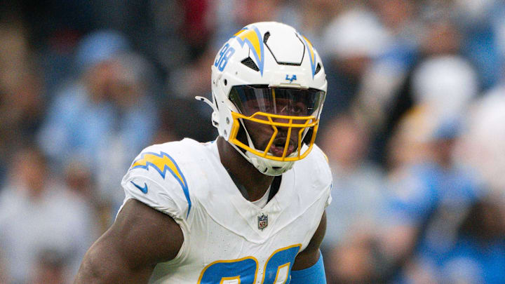 Nov 2, 2025; Nashville, Tennessee, USA;  Los Angeles Chargers linebacker Odafe Oweh (98) celebrates his sack with linebacker Tuli Tuipulotu (45) against the Tennessee Titans during the second half at Nissan Stadium. Mandatory Credit: Steve Roberts-Imagn Images