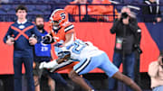 Oct 31, 2025; Syracuse, New York, USA; Syracuse Orange running back Will Nixon (24) is tackled by North Carolina Tar Heels defensive back Jalon Thompson (20) in the fourth quarter at the JMA Wireless Dome. 