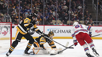 Feb 23, 2025; Pittsburgh, Pennsylvania, USA;  Pittsburgh Penguins goaltender Joel Blomqvist (30) makes a save against New York Rangers right wing Reilly Smith (91) as Penguins defenseman P.O Joseph (73) assists in defending during the third period at PPG Paints Arena. Mandatory Credit: Charles LeClaire-Imagn Images