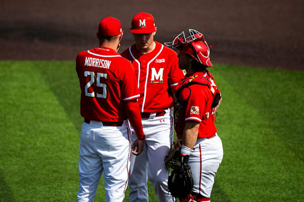 Maryland pitcher Jason Savacool conferences with assistant coach Mike Morrison during a NCAA Big Ten Conference baseball game