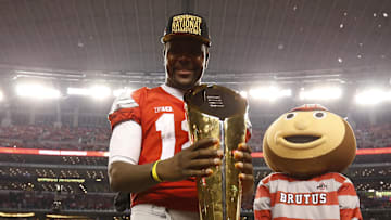 Jan 12, 2015; Arlington, TX, USA; Ohio State Buckeyes quarterback Cardale Jones (12) celebrates with the College Playoff trophy after the game against the Oregon Ducks in the 2015 CFP National Championship Game at AT&T Stadium. Mandatory Credit: Matthew Emmons-Imagn Images