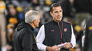 Nov 2, 2024; Iowa City, Iowa, USA; Iowa Hawkeyes head coach Kirk Ferentz (left) and Wisconsin Badgers head coach Luke Fickell (right) talk before the game at Kinnick Stadium. Mandatory Credit: Jeffrey Becker-Imagn Images