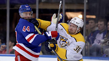 Mar 2, 2025; New York, New York, USA; Nashville Predators left wing Cole Smith (36) and New York Rangers defenseman Calvin de Haan (44) fight for position during the first period at Madison Square Garden. Mandatory Credit: Brad Penner-Imagn Images