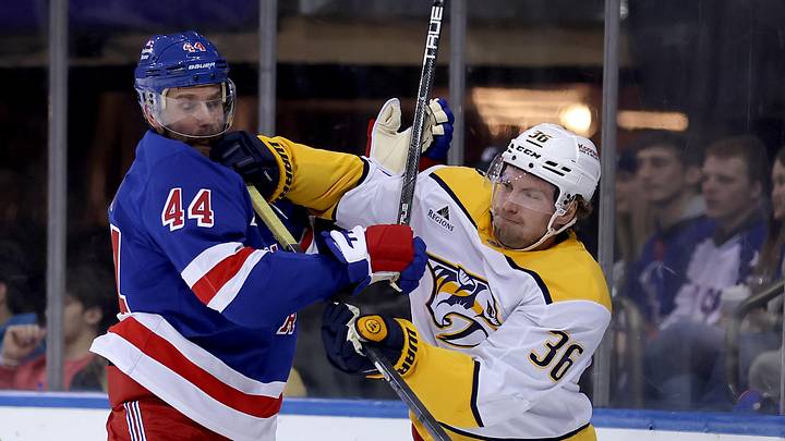 Mar 2, 2025; New York, New York, USA; Nashville Predators left wing Cole Smith (36) and New York Rangers defenseman Calvin de Haan (44) fight for position during the first period at Madison Square Garden. Mandatory Credit: Brad Penner-Imagn Images