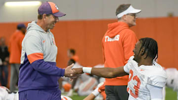 Clemson head coach Dabo Swinney greets cornerback Ashton Hampton (23) during the football practice at the Allen N. Reeves Football Complex at Clemson University in Clemson, S.C. Monday, March 3, 2025.