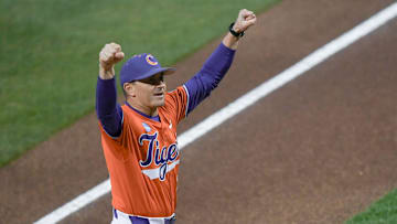 Clemson Head Coach Erik Bakich pumps his fists toward fans before the first pitch with South Carolina at Doug Kingsmore Stadium in Clemson, S.C. Wednesday, Feb 28, 2025.