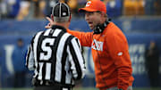 Nov 16, 2024; Pittsburgh, Pennsylvania, USA;  Clemson Tigers head coach Dabo Swinney (right) reacts to side judge Rick Santilli on the sidelines against the Pittsburgh Panthers during the fourth quarter at Acrisure Stadium. Mandatory Credit: Charles LeClaire-Imagn Images