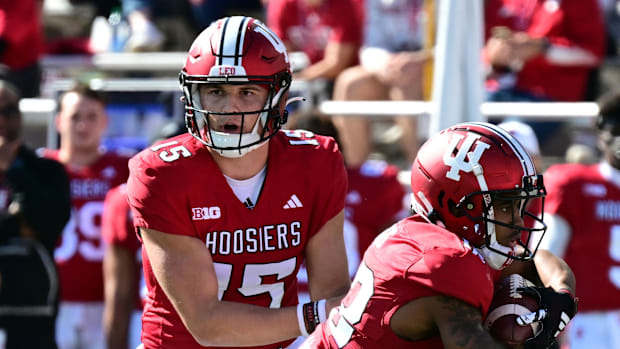 Indiana Hoosiers quarterback Brendan Sorsby (15) hands the ball off to Indiana Hoosiers running back Jaylin Lucas