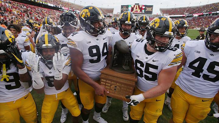 Iowa Football team celebrates with Cy-Hawk Trophy after winning 20-13 over Iowa State at the Jack Trice Stadium on Saturday, Sept. 9, 2023, in Ames, Iowa.