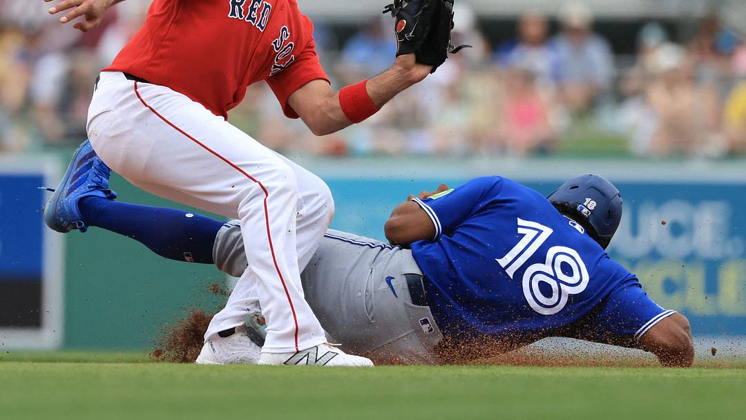 Boston Red Sox infielder Isiah Kiner-Falefa (2) tags out Toronto Blue Jays infielder Arjun Nimmala (18)  after he attempted to steal second base during the first inning  at JetBlue Park at Fenway South on Feb. 22, 2026.