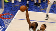 Jun 12, 2024; Dallas, Texas, USA; Boston Celtics guard Jaylen Brown (7) dunks against Dallas Mavericks forward P.J. Washington (25) and guard Josh Green (8) during the third quarter in game three of the 2024 NBA Finals at American Airlines Center. Mandatory Credit: Peter Casey-USA TODAY Sports