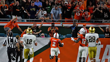 Nov 11, 2017; Miami Gardens, FL, USA; Miami Hurricanes defensive back Trajan Bandy (2) runs into the end zone to score a touchdown after intercepting a pass from Notre Dame Fighting Irish quarterback Ian Book (12) during the first half at Hard Rock Stadium. Mandatory Credit: Jasen Vinlove-Imagn Images