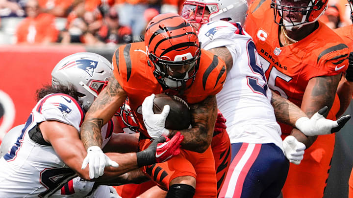 Cincinnati Bengals halfback Chase Brown (30) runs throgh the New England Patriots defense in the Bengals home opener against at Paycor Stadium Sunday, September 8, 2024. The Bengals lost 16-10.