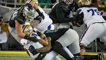 Oregon outside linebackers Matayo Uiagalelei, right, and Teitum Tuioti, left, sack Washington quarterback Demond Williams Jr. as the No. 1 Oregon Ducks host the Washington Huskies Saturday, Nov. 30, 2024 at Autzen Stadium in Eugene, Ore.