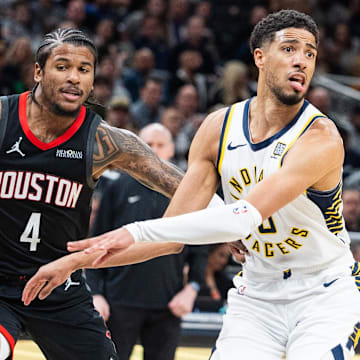 Mar 4, 2025; Indianapolis, Indiana, USA; Indiana Pacers guard Tyrese Haliburton (0) passes the ball while Houston Rockets guard Jalen Green (4) defends in the second half at Gainbridge Fieldhouse. Mandatory Credit: Trevor Ruszkowski-Imagn Images